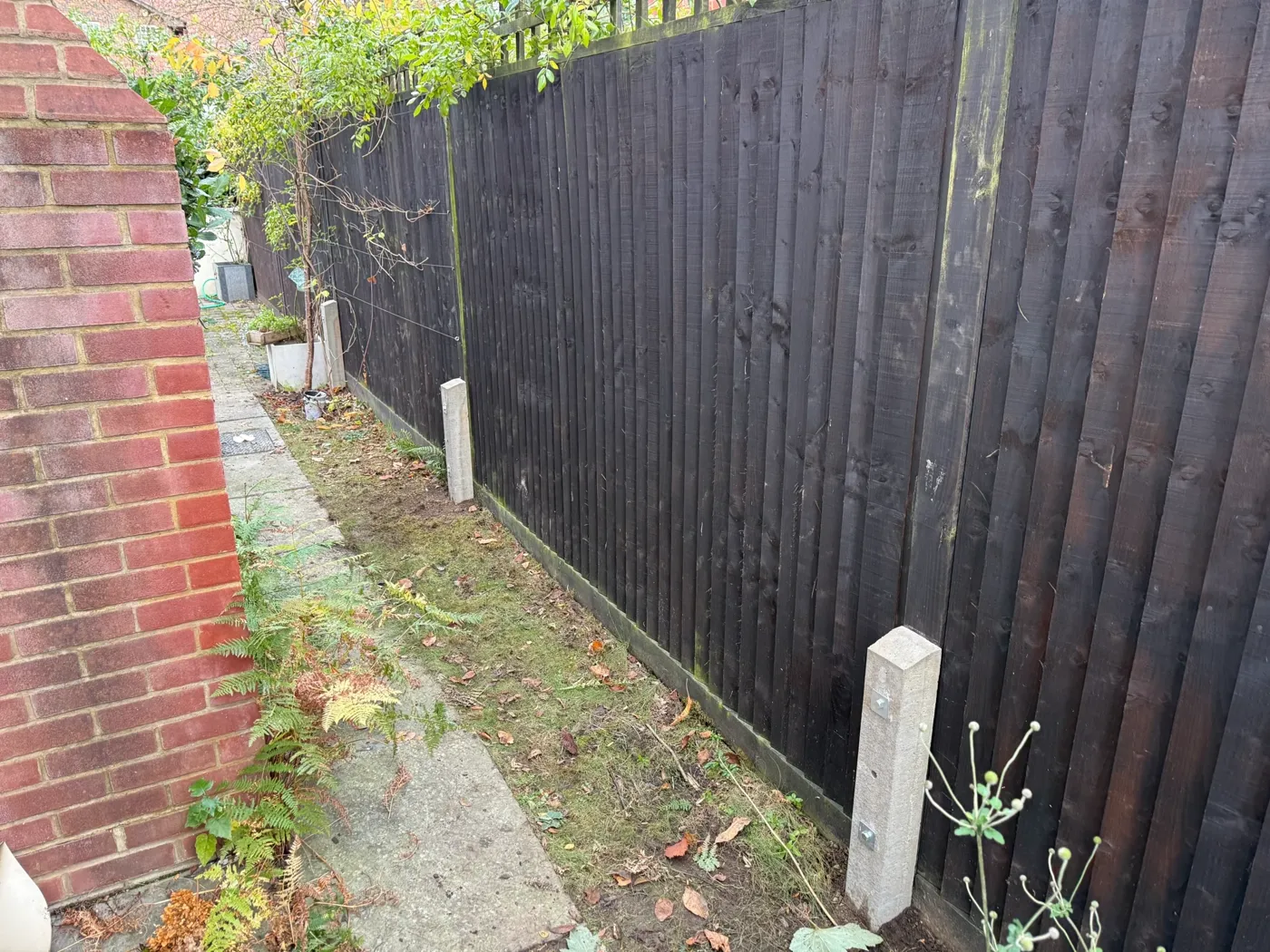 Damaged fence panel being repaired