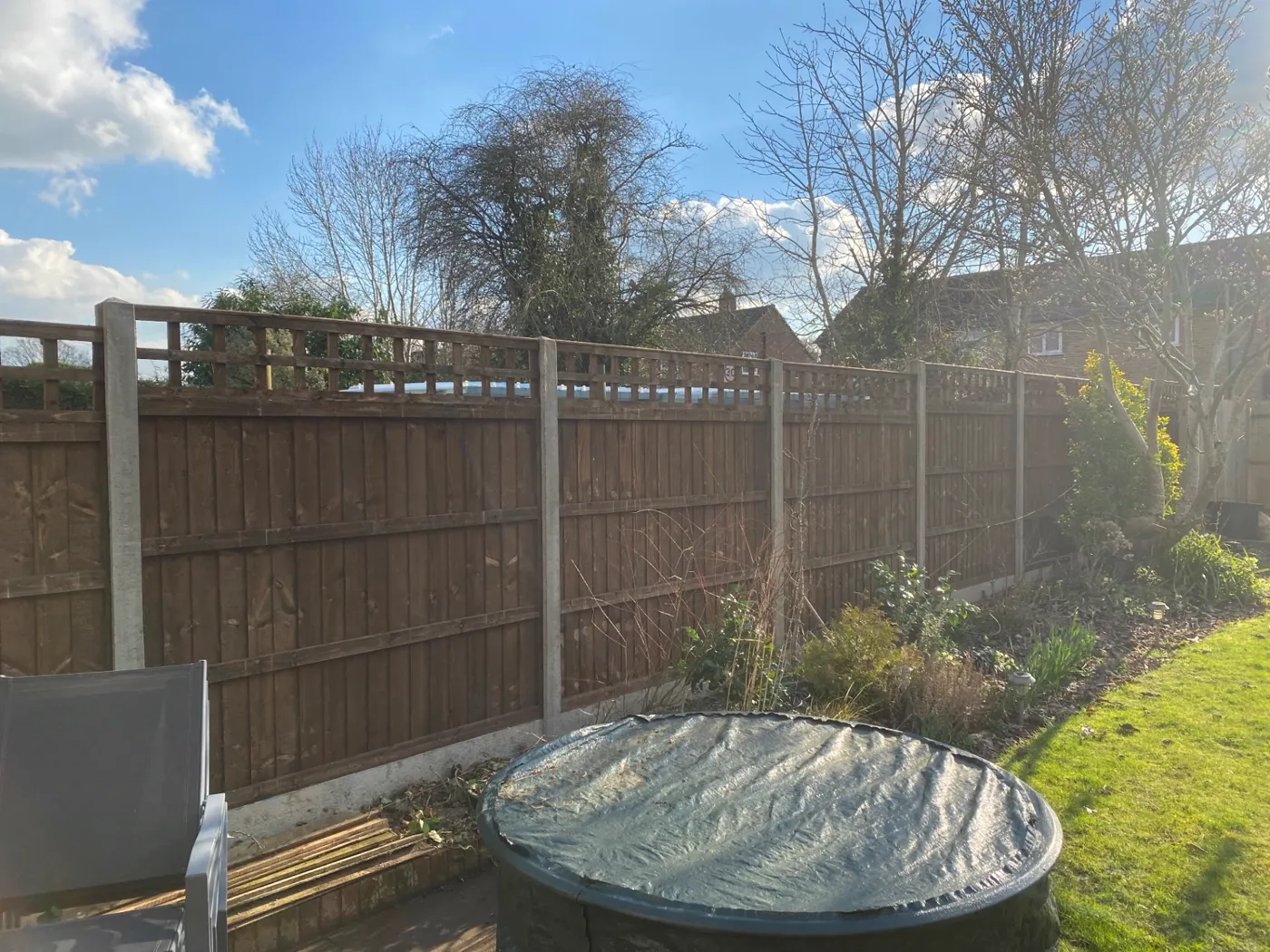 Trellis topped fence panels installed for added privacy in a garden